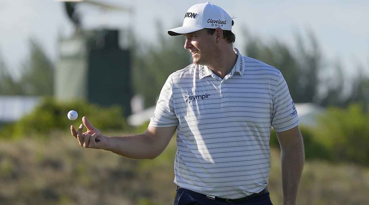 Sepp Straka tosses his ball to his caddie at the first round of the 2022 Hero World Challenge.