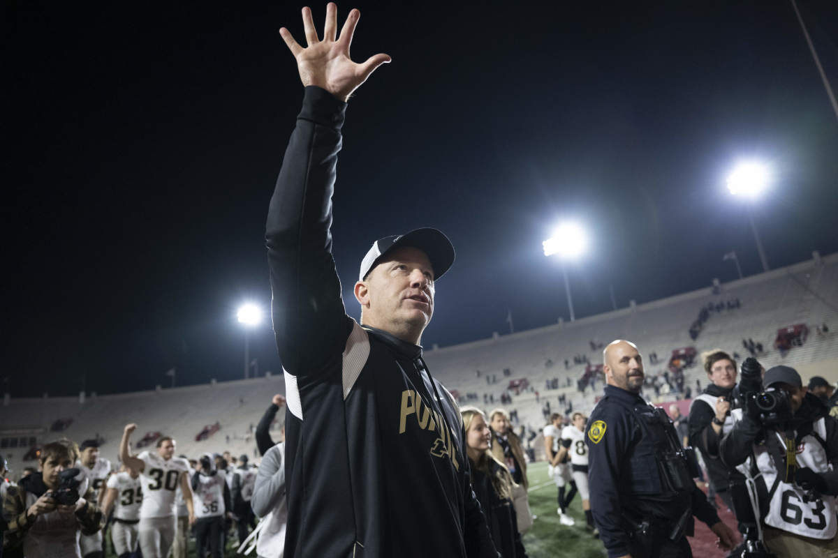 Purdue Boilermakers head coach Jeff Brohm waves toward the fan section