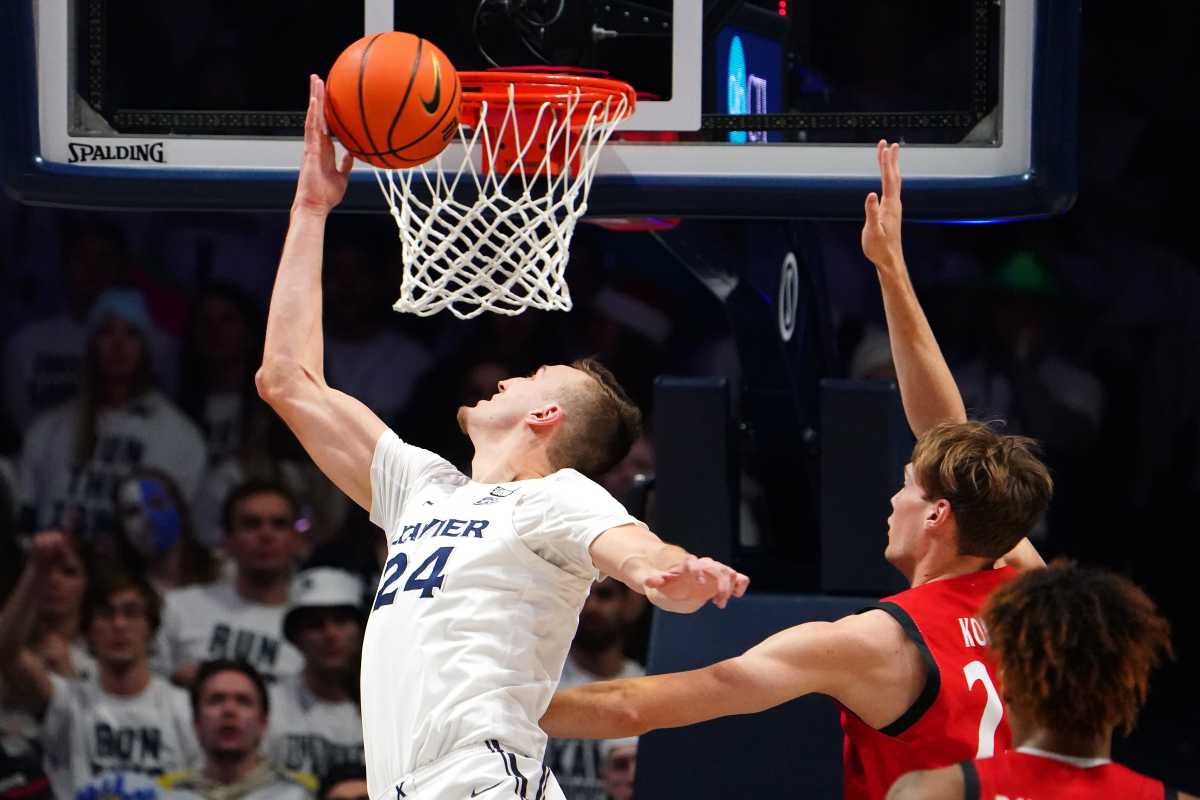 Xavier Musketeers forward Jack Nunge (24) rises to the basket as Cincinnati Bearcats center Hayden Koval (25) defends in the first half of the 89th Annual Crosstown Shootout college basketball game, Saturday, Dec. 11, 2021, at Cintas Center in Cincinnati. Xavier Musketeers At Cincinnati Bearcats 89th Crosstown Shootout Dec 11