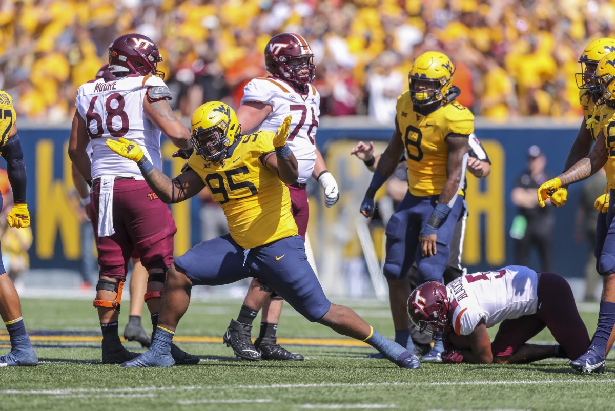 Sep 18, 2021; Morgantown, West Virginia, USA; West Virginia Mountaineers defensive lineman Jordan Jefferson (95) celebrates after a defensive stop during the first quarter against the Virginia Tech Hokies at Mountaineer Field at Milan Puskar Stadium.