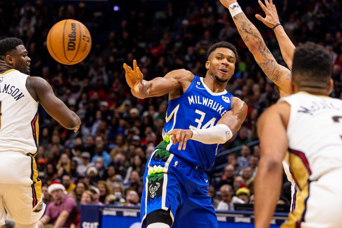 Milwaukee Bucks forward Giannis Antetokounmpo (34) passes the ball past New Orleans Pelicans forward Zion Williamson (1)