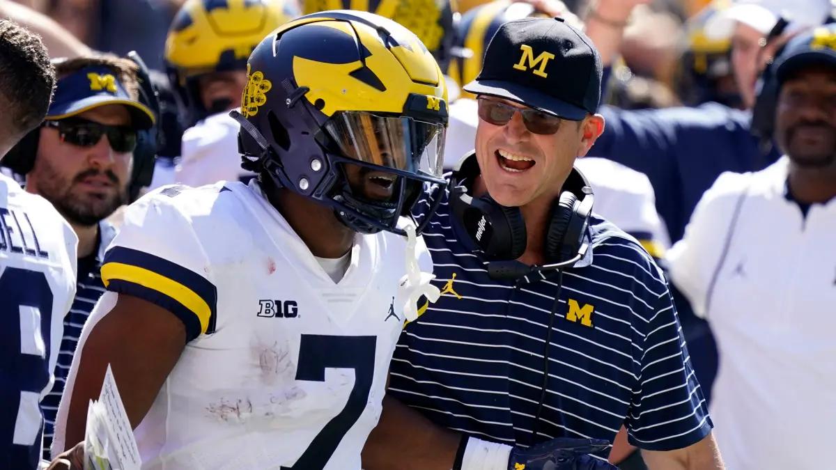 Michigan running back Donovan Edwards (7) and head coach Jim Harbaugh.