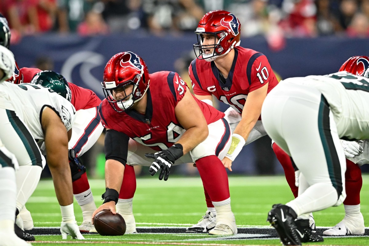 Houston Texans quarterback Davis Mills (10) receives the snap from center Scott Quessenberry (54) during the first quarter against the Philadelphia Eagles at NRG Stadium.