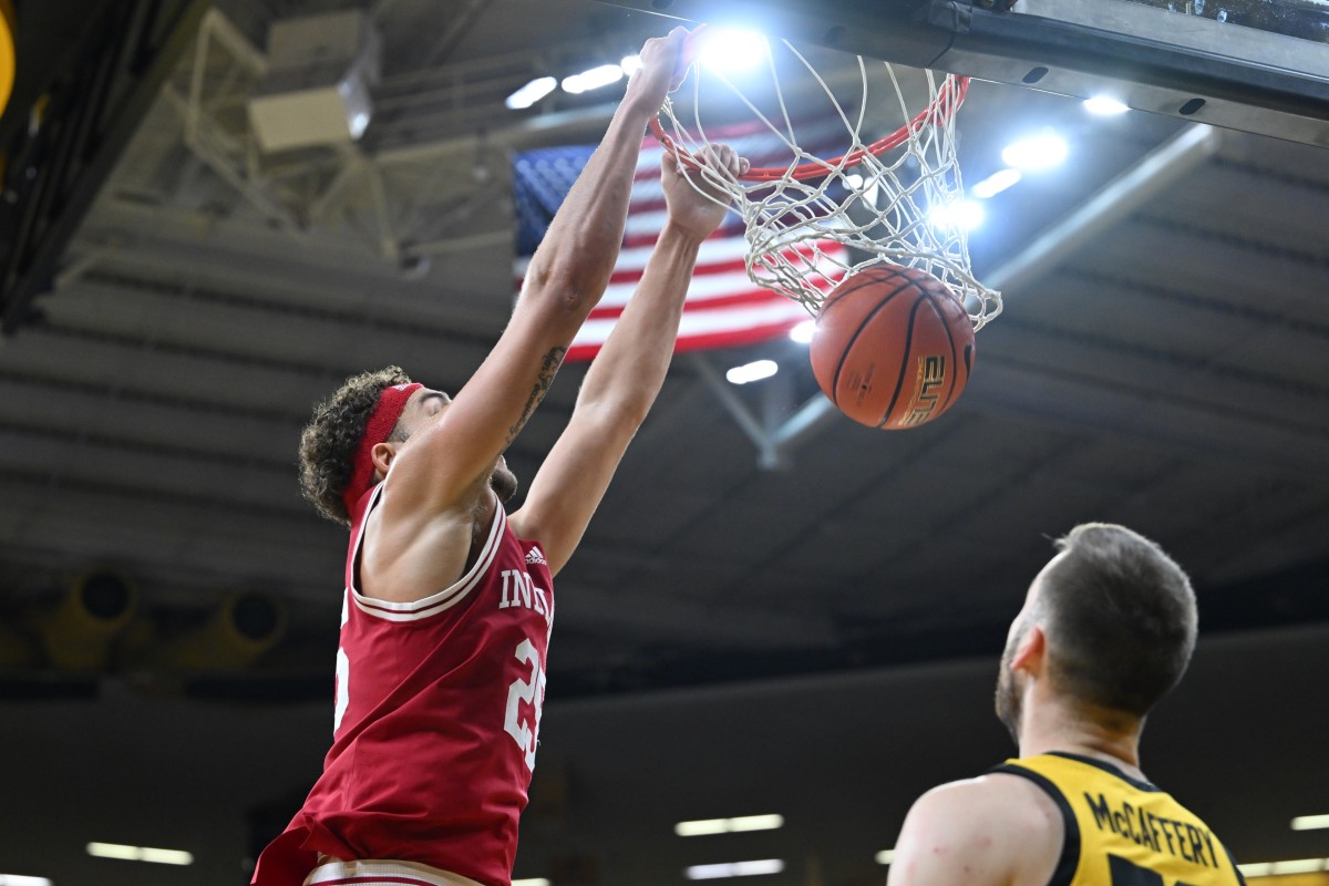 Indiana Hoosiers forward Race Thompson (25) completes a slam dunk over Iowa Hawkeyes guard Connor McCaffery (30) during the first half at Carver-Hawkeye Arena.