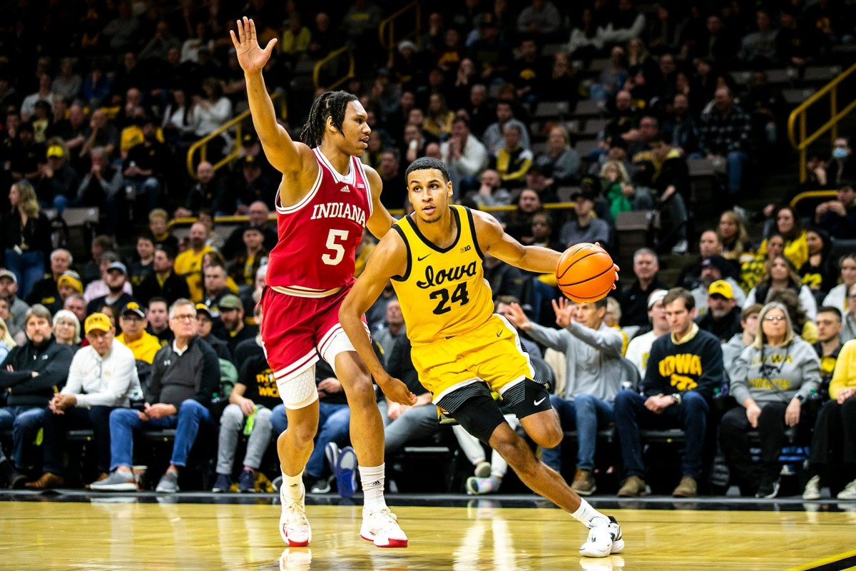 Iowa forward Kris Murray (24) drives to the basket as Indiana forward Malik Reneau (5) defends during a NCAA Big Ten Conference men's basketball game.