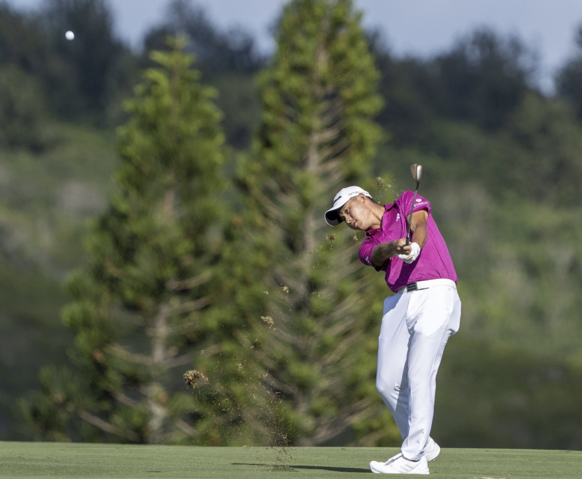 Collin Morikawa hits off the fairway at the Sentry TOC