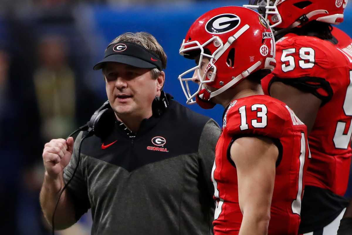 Georgia coach Kirby Smart speaks with Georgia quarterback Stetson Bennett (13) during the second half of the Chick-fil-A Peach Bowl NCAA College Football Playoff semifinal game between Ohio State and Georgia on Saturday, Dec 31, 2022, in Atlanta.