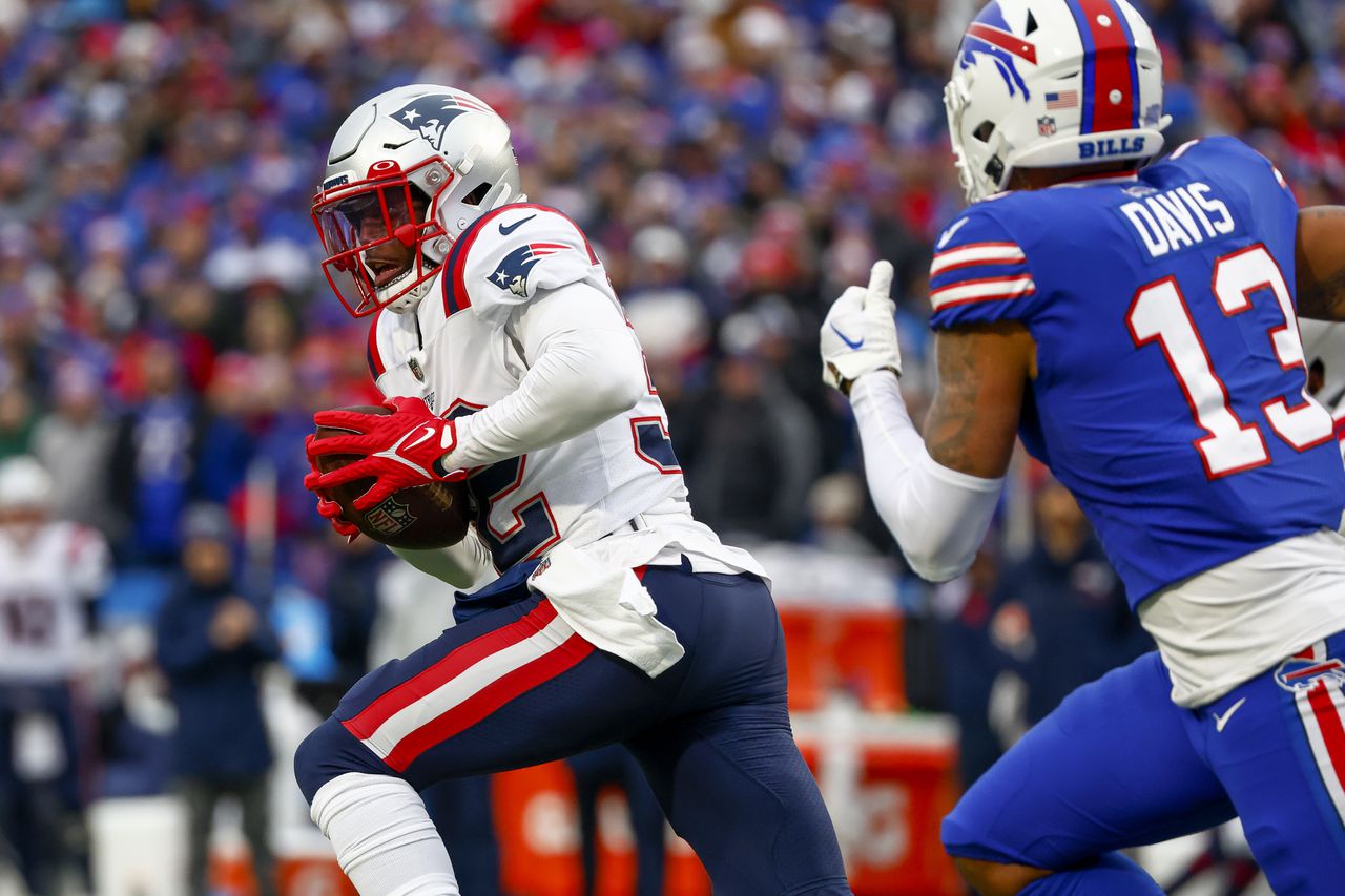 New England Patriots safety Devin McCourty (32) runs back an interception during the first half of an NFL football game against the Buffalo Bills, Sunday, Jan. 8, 2023, in Orchard Park.