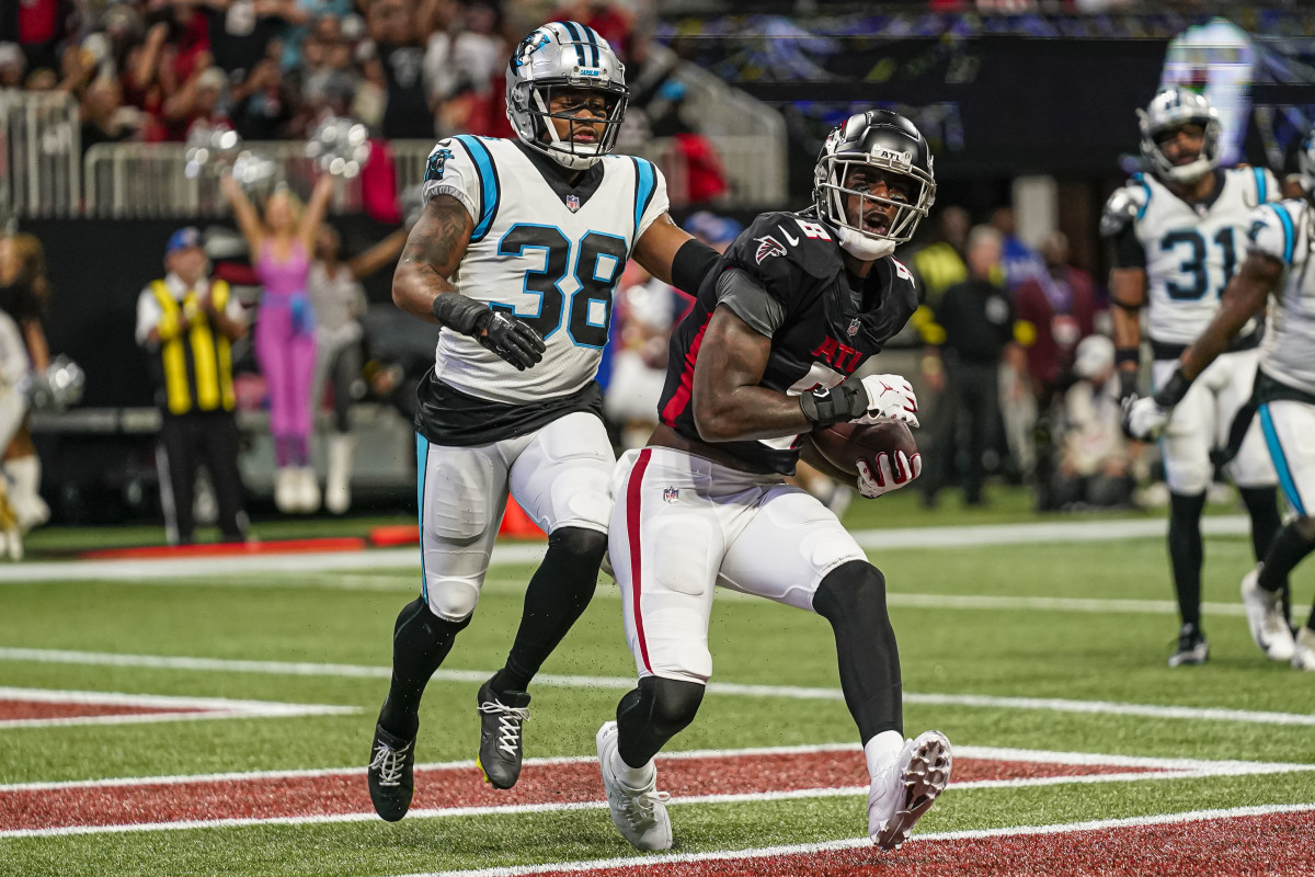 Oct 30, 2022; Atlanta, Georgia, USA; Atlanta Falcons tight end Kyle Pitts (8) catches a touchdown pass behind Carolina Panthers cornerback Myles Hartsfield (38) during the first half at Mercedes-Benz Stadium.