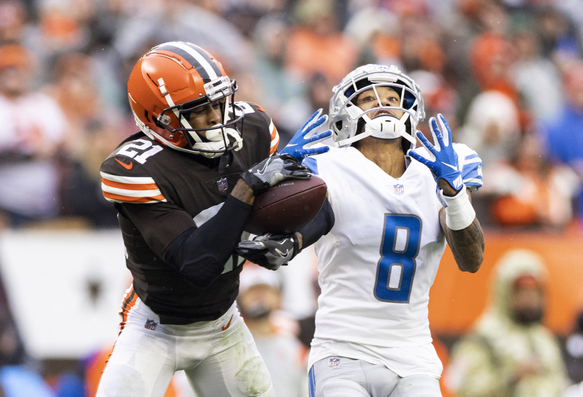 Nov 21, 2021; Cleveland, Ohio, USA; Cleveland Browns cornerback Denzel Ward (21) intercepts the ball from Detroit Lions wide receiver Josh Reynolds (8) during the third quarter at FirstEnergy Stadium.