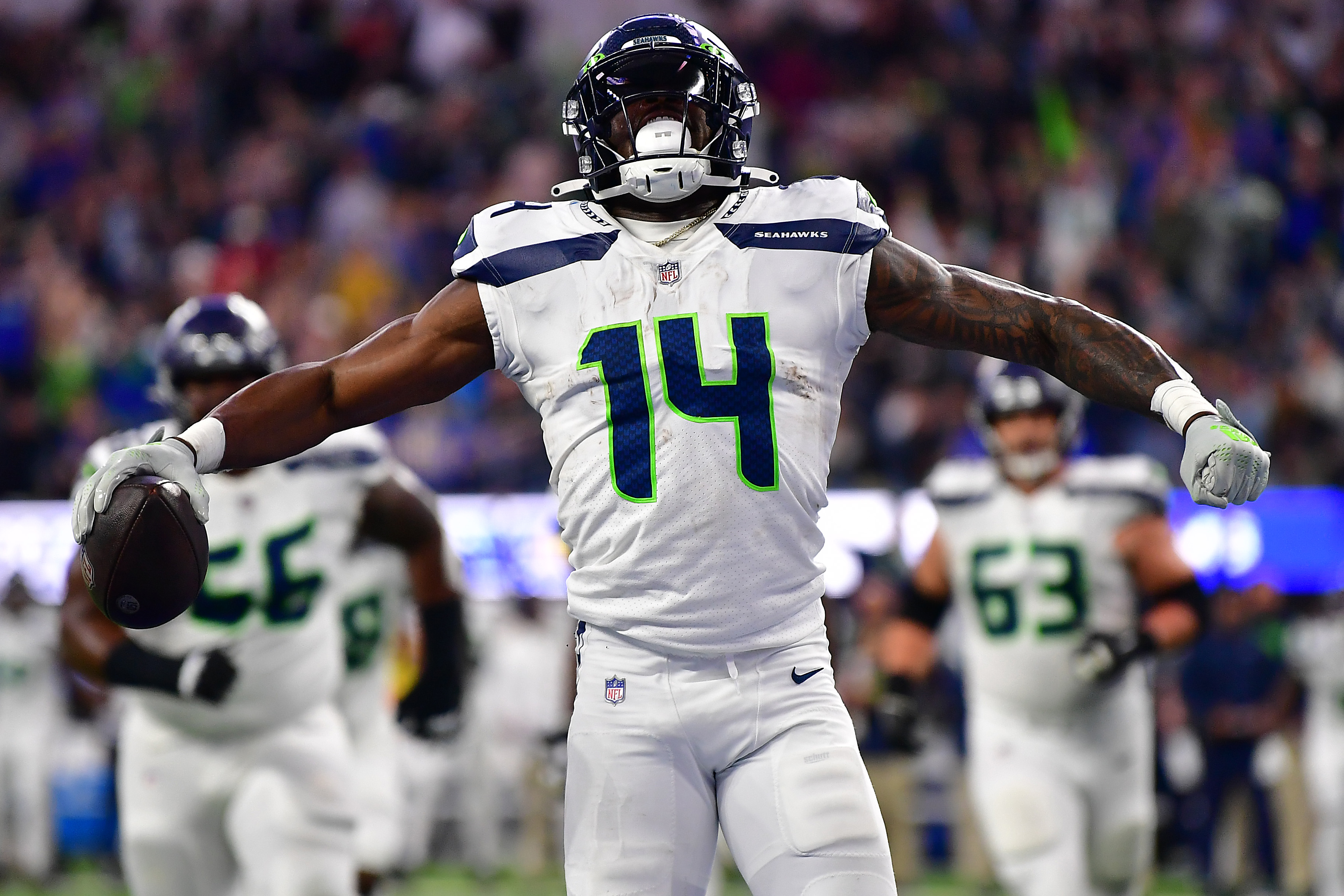 Seattle Seahawks wide receiver DK Metcalf (14) catches a touchdown against  San Francisco 49ers cornerback Charvarius Ward (7) during the first half of  an NFL wild card playoff football game in Santa