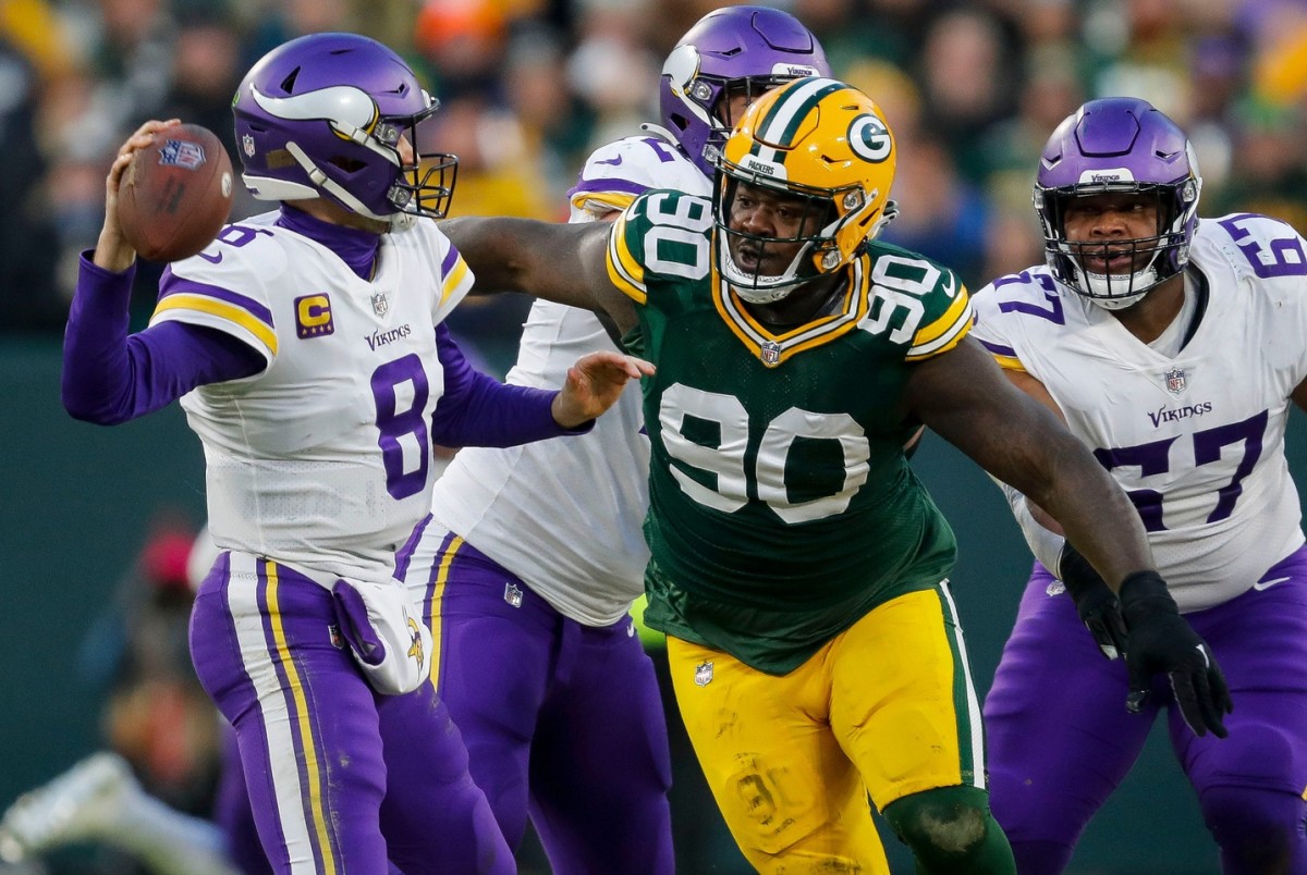 Green Bay Packers defensive tackle Jarran Reed (90) rushes Minnesota Vikings quarterback Kirk Cousins (8) as he passes the ball on Sunday, January 1, 2023, at Lambeau Field in Green Bay, WI.