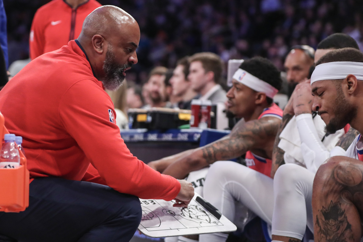 Wizards HC Wes Unseld Jr draws up a play out of a timeout - USA Today