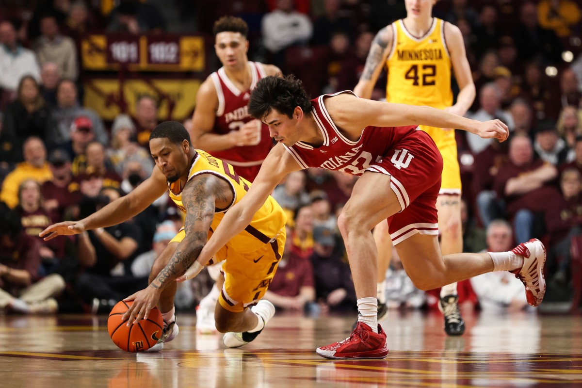 Indiana Hoosiers guard Trey Galloway (32) and Minnesota Golden Gophers guard Ta'lon Cooper (55) dive for the ball during the second half at Williams Arena.