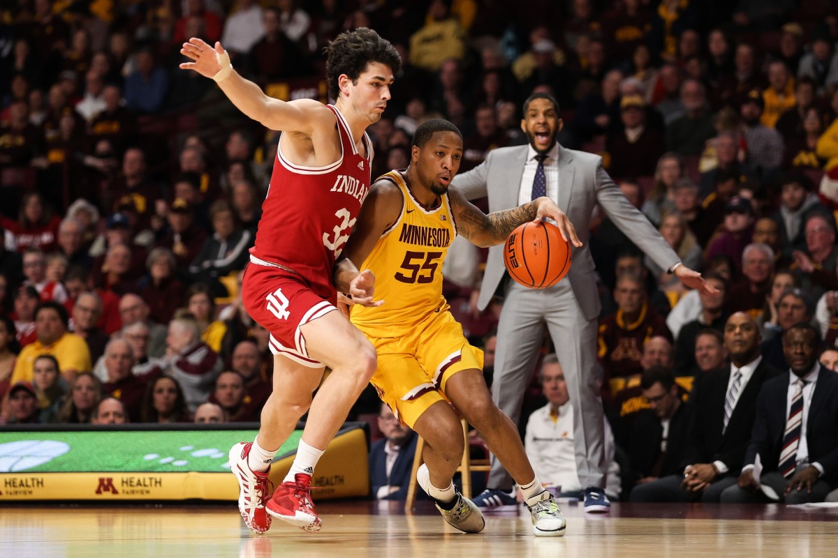 Minnesota Golden Gophers guard Ta'lon Cooper (55) dribbles while Indiana Hoosiers guard Trey Galloway defends.