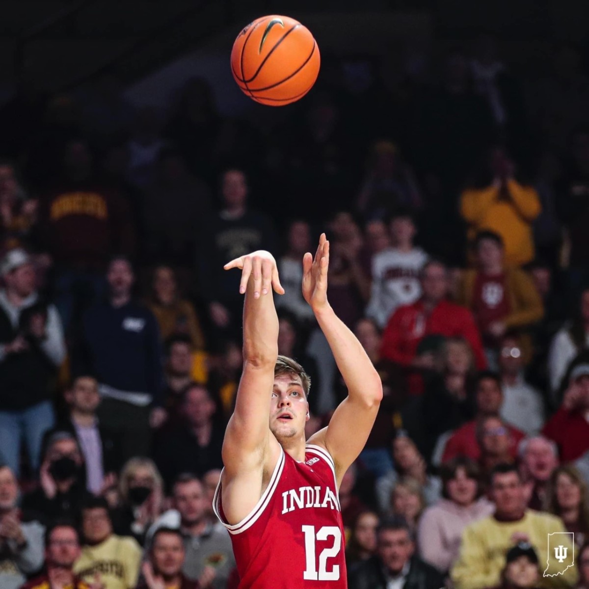 Miller Kopp (12) fires a three point basket during the first half of Indiana's matchup with Minnesota on Wednesday.