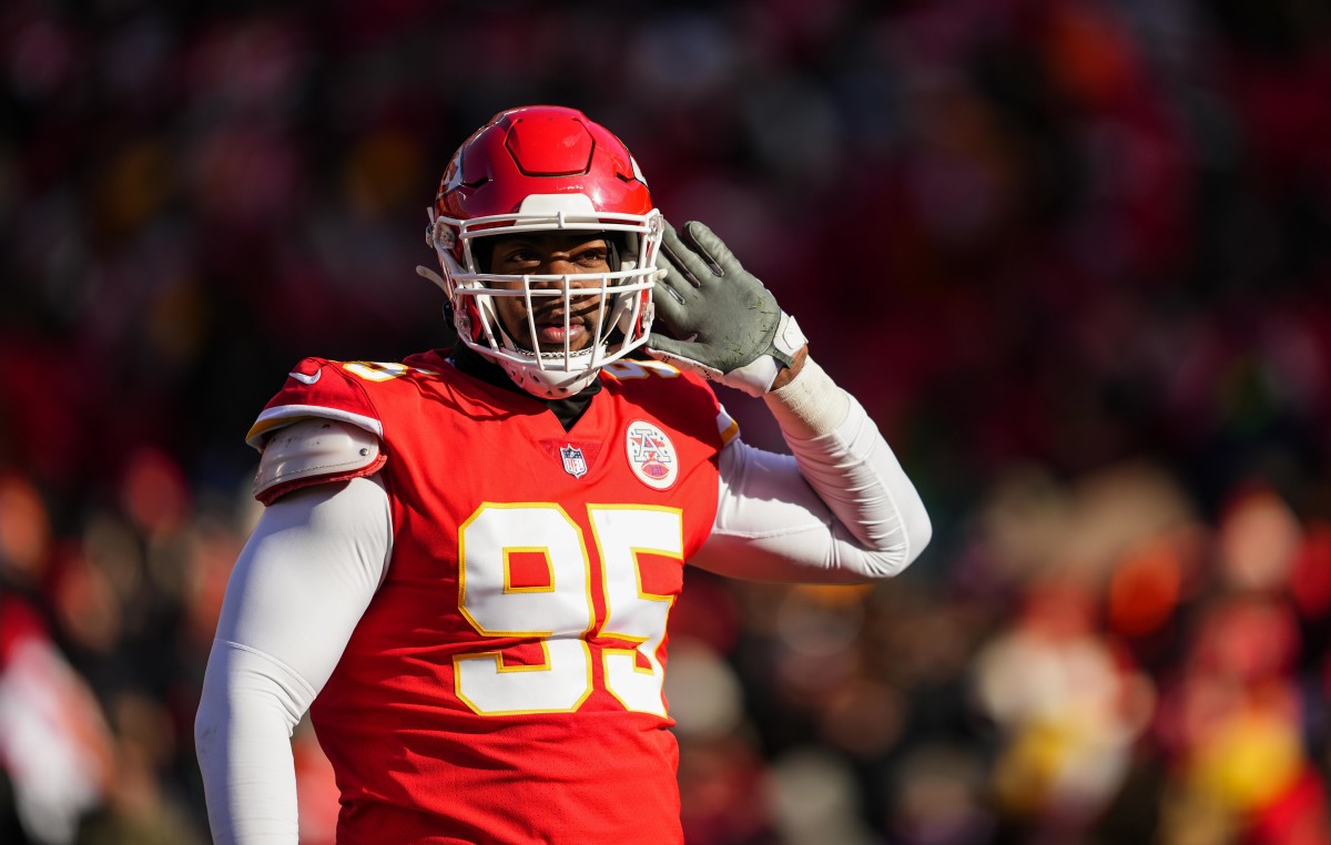 Chris Jones gestures to the crowd before the snap during a Chiefs game