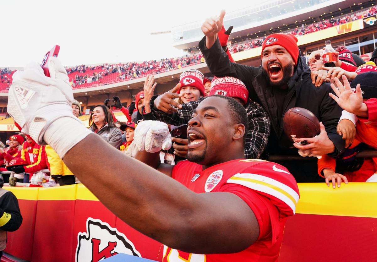 Chris Jones takes a selfie with Chiefs fans after a game