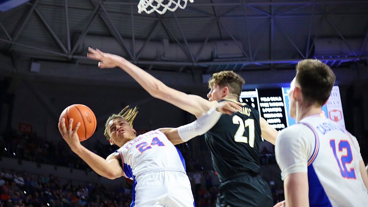 Riley Kugel makes an acrobatic finish by going up and under Vanderbilt big man Liam Roberts.