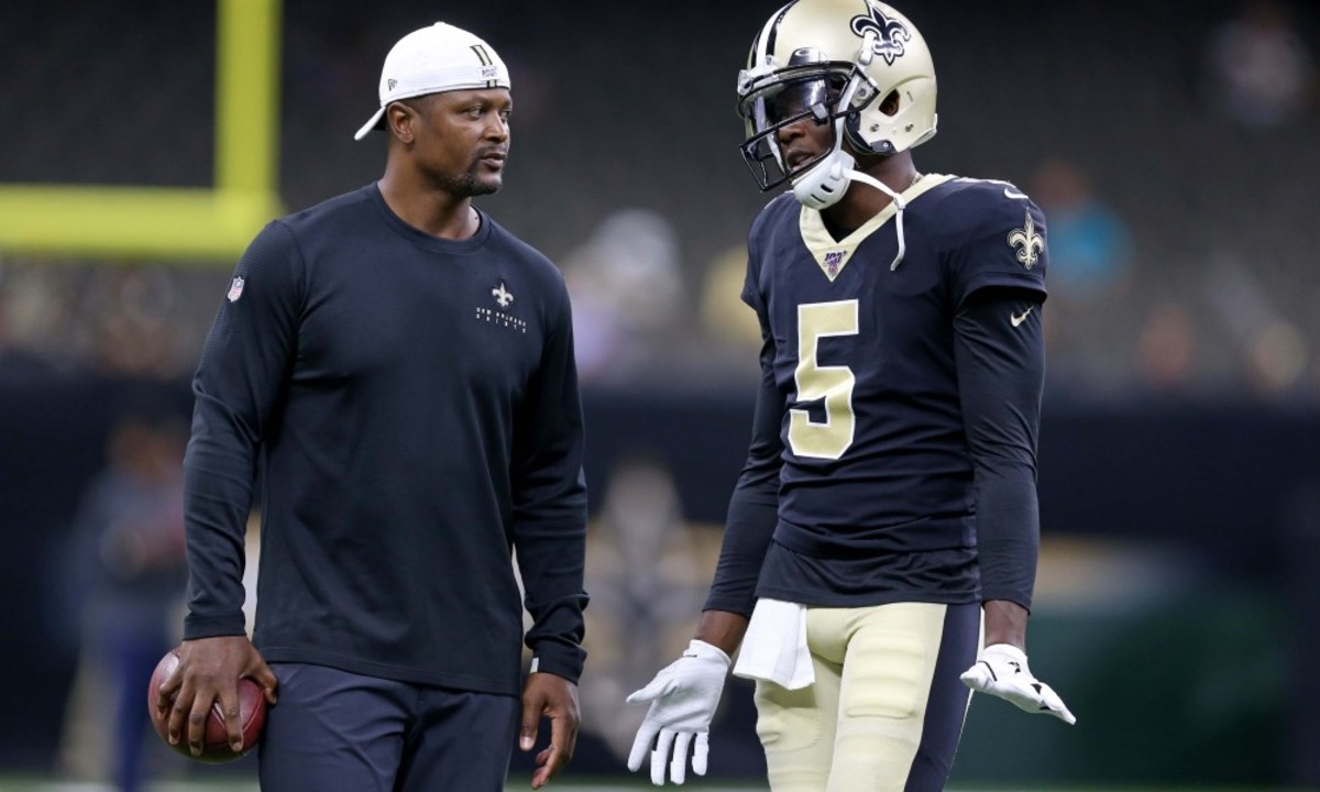 New Orleans Saints quarterback Teddy Bridgewater (5) talks to wide receivers coach Ronald Curry before their game