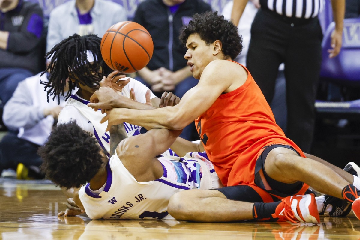 Demonstrating how sloppy things got, Oregon State's Michael Rataj and the UW's Keyon Menifield and Keion Brooks battle for the ball -- all seated.