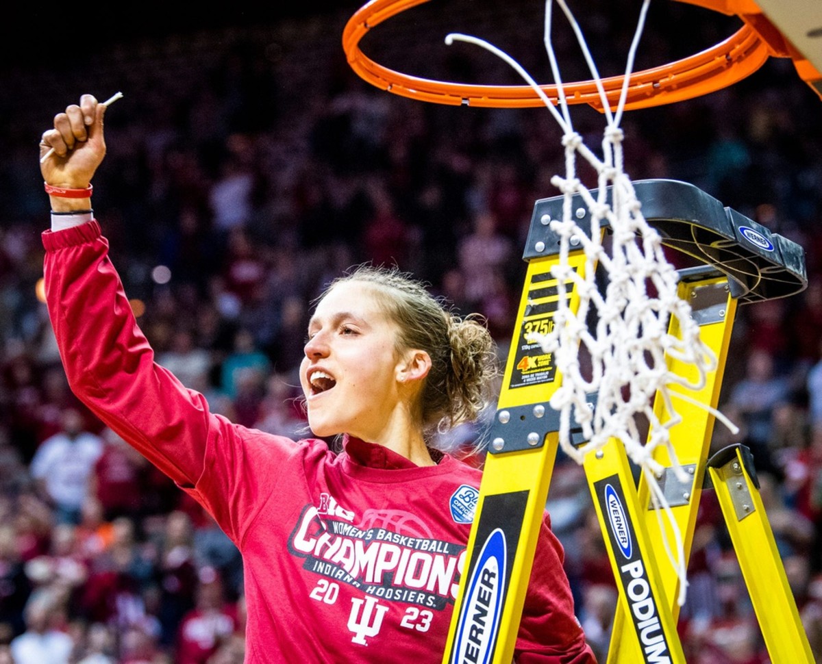 Indiana Team and Recruitment Coordinator Ali Patberg celebrates after cutting down part of the net after the second half of the Indiana versus Purdue women's basketball game at Simon Skjodt Assembly Hall on Sunday, Feb. 19, 2023.