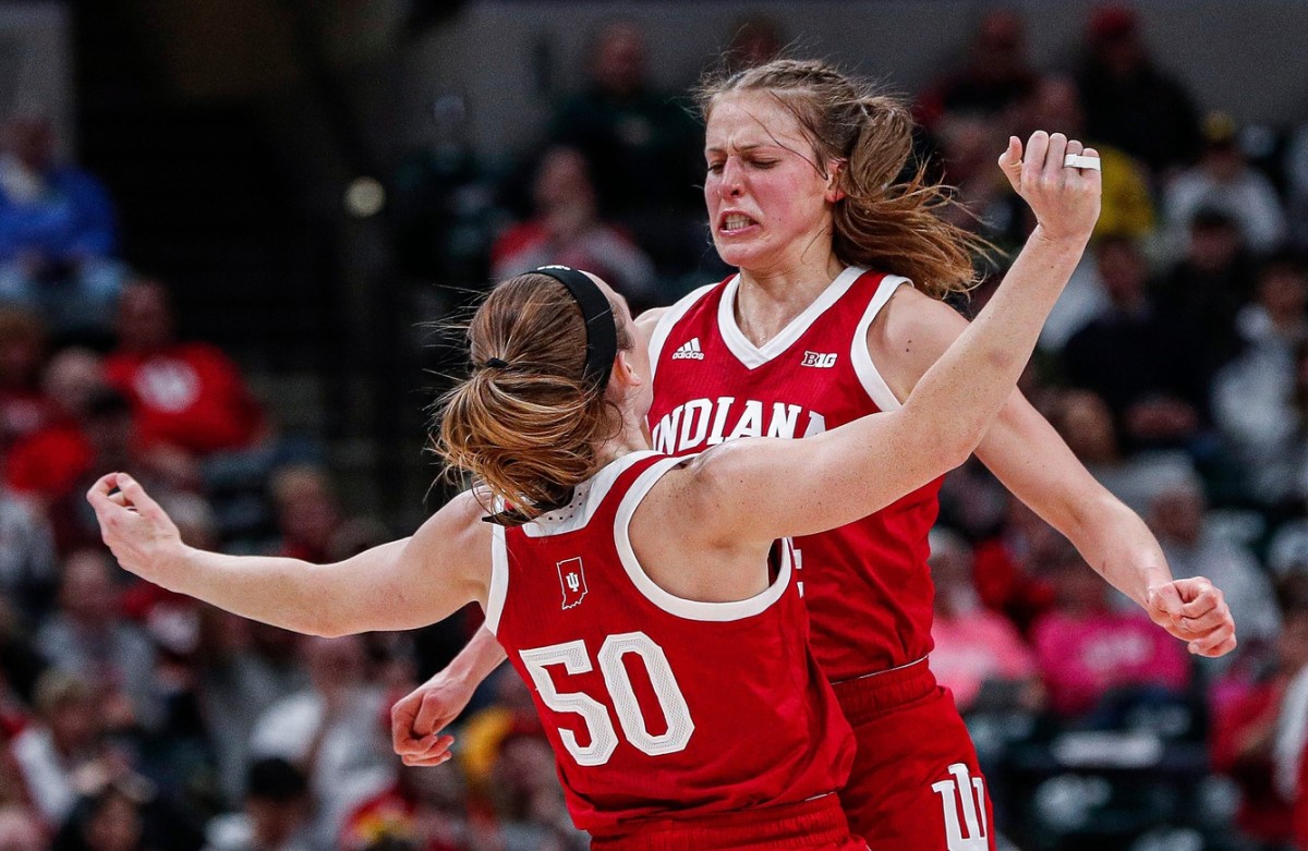 Indiana Hoosiers guard Ali Patberg (14) runs to Indiana Hoosiers forward Brenna Wise (50) for a chest bump after scoring a point during the Big Ten Semifinals at Bankers Life Fieldhouse in Indianapolis, Saturday, March 7, 2020.