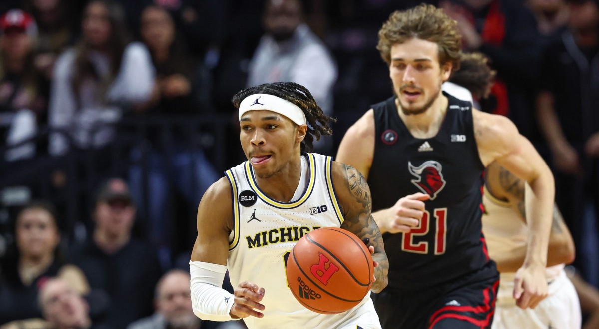 Michigan guard Dug McDaniel (0) drives to the basket ahead of Rutgers forward Dean Reiber (21) on Thursday. (Vincent Carchietta-USA TODAY Sports)