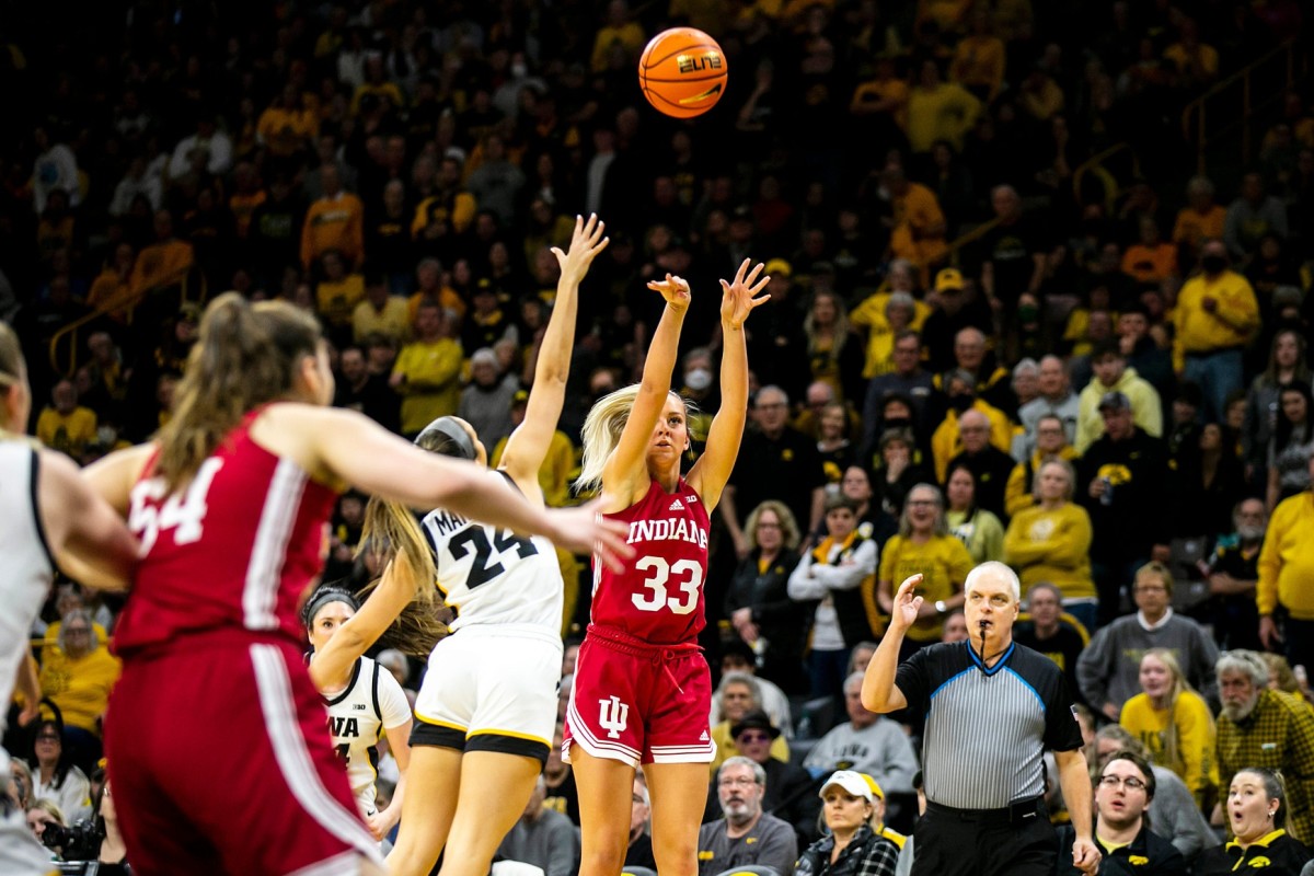 Indiana guard Sydney Parrish (33) makes a 3-point basket as Iowa guard Gabbie Marshall defends during a NCAA Big Ten Conference women's basketball game, Sunday, Feb. 26, 2023, at Carver-Hawkeye Arena in Iowa City, Iowa.