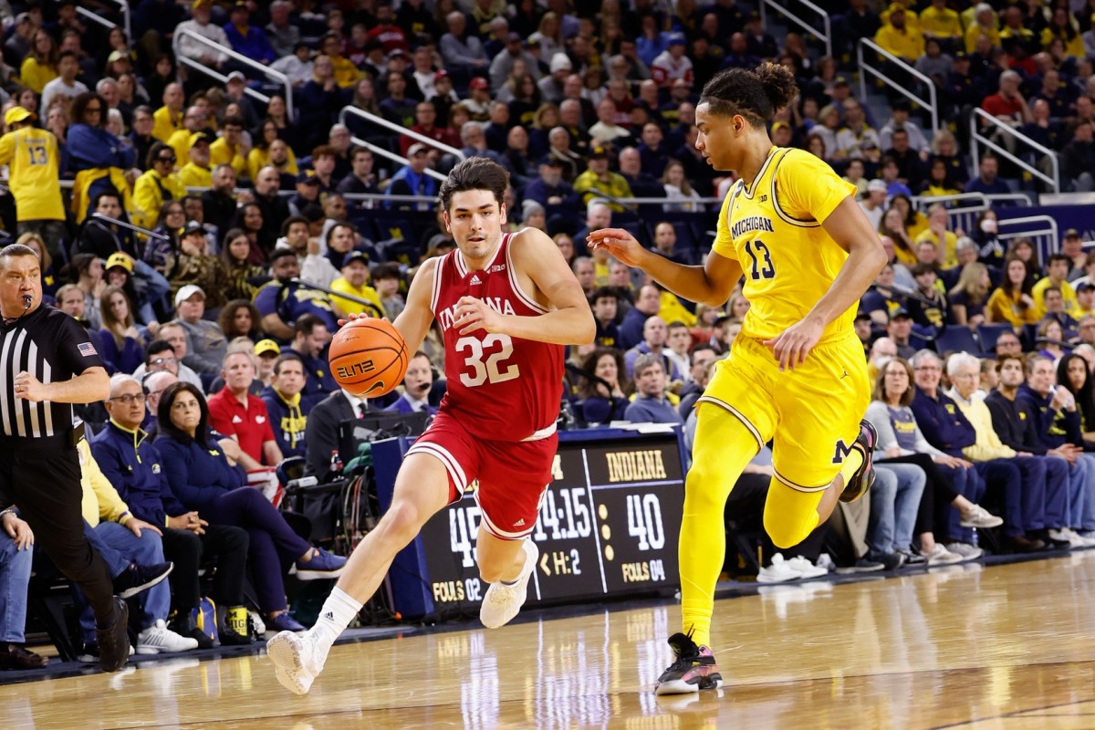 Indiana Hoosiers guard Trey Galloway (32) drives against Michigan Wolverines guard Jett Howard (13) at Crisler Center.