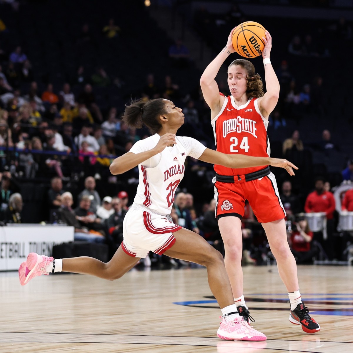 Mar 4, 2023; Minneapolis, Minn., USA; Ohio State Buckeyes guard Taylor Mikesell (24) looks to pass while Indiana Hoosiers guard Chloe Moore-McNeil (22) defends during the first half at Target Center.