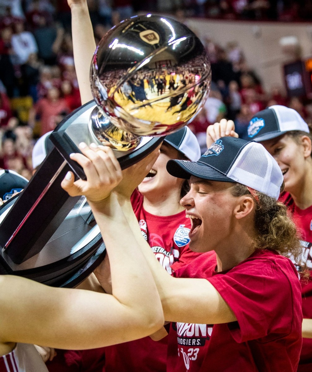 Indiana's Grace Berger (34) helps hoist the Big Ten championship trophy after the second half of the Indiana versus Purdue women's basketball game at Simon Skjodt Assembly Hall on Sunday, Feb. 19, 2023.