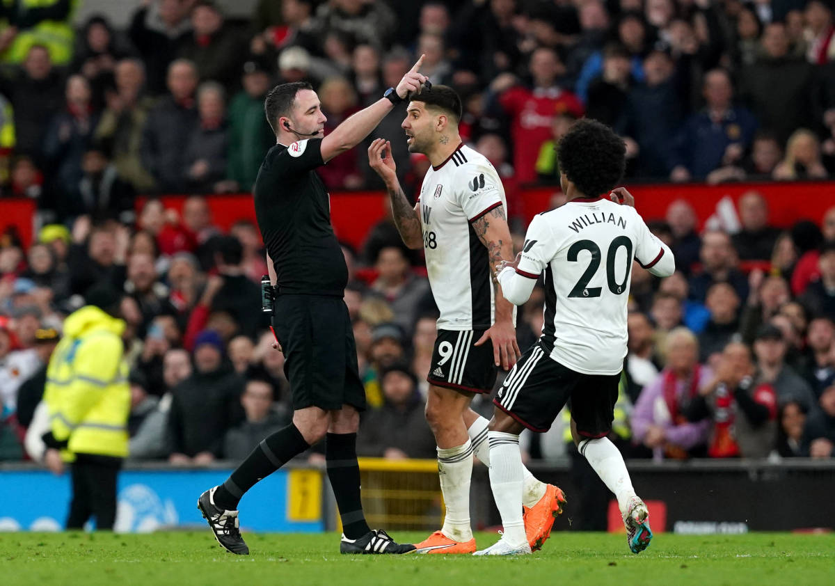 Referee Chris Kavanagh pictured (left) after showing red cards to Aleksandar Mitrovic (center) and Willian (right) during Fulham's 3-1 loss to Manchester United in March 2023