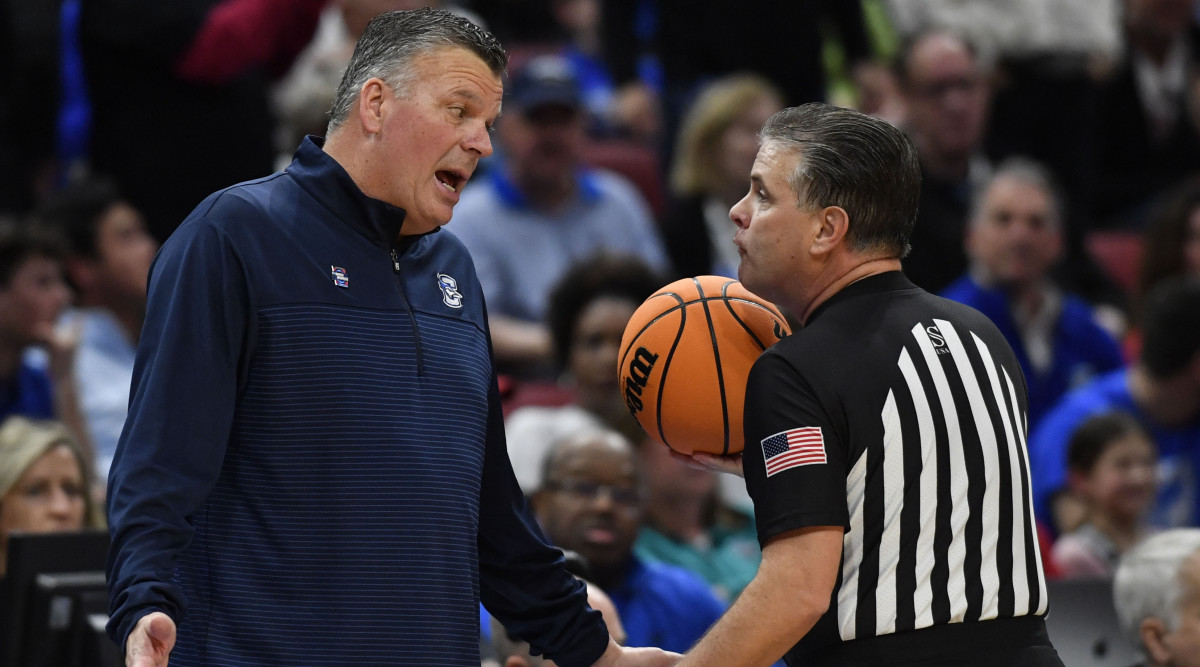 Creighton head coach Greg McDermott speaks with an official during a 2023 Elite Eight game against San Diego State