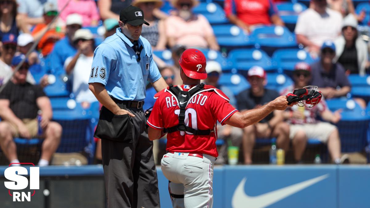 Philadelphia Phillies - J.T. Realmuto, wearing the red pinstripe uniform,  pointing to the dugout after driving in a run.