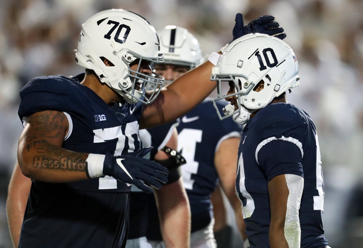 Oct 22, 2022; University Park, Pennsylvania, USA; Penn State Nittany Lions running back Nicholas Singleton (10) celebrates with offensive linesman Juice Scruggs (70) after scoring a touchdown during the third quarter against the Minnesota Golden Gophers at Beaver Stadium. Penn State defeated Minnesota 45-17. Mandatory Credit: Matthew OHaren-USA TODAY Sports