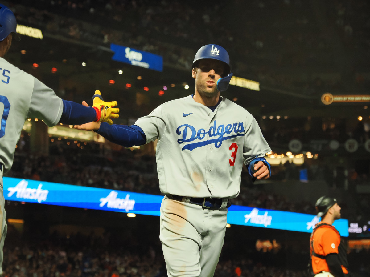 Los Angeles Dodgers second baseman Chris Taylor (3) high fives a teammate after scoring a run against the San Francisco Giants during the fourth inning at Oracle Park.