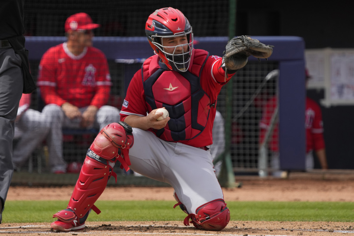 Los Angeles Angels catcher Matt Thaiss (21) checks a swing against the San Diego Padres in the first inning at Peoria Sports Complex.