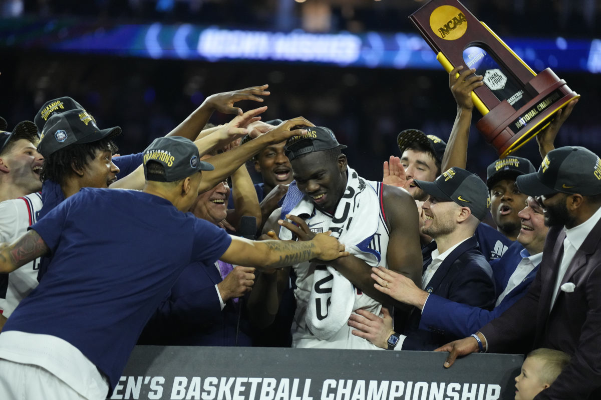 Adama Sanogo is congratulated by his teammates and coaches after winning MVP honors in the FInal Four.