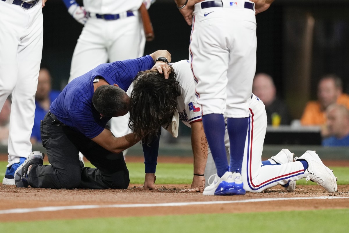 Rangers' Smith goes to hospital after hit in face with pitch