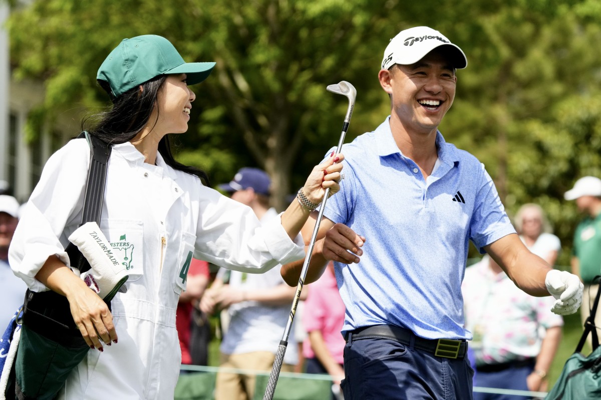 Collin Morikawa with wife Kat serving as his practice round caddie