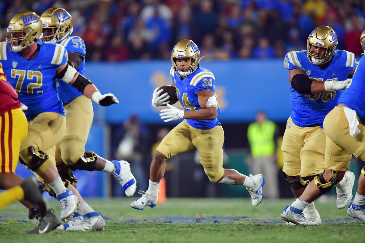 Nov 19, 2022; UCLA Bruins running back Zach Charbonnet (24) runs the ball against the USC Trojans. Mandatory Credit: Gary A. Vasquez-USA TODAY Sports