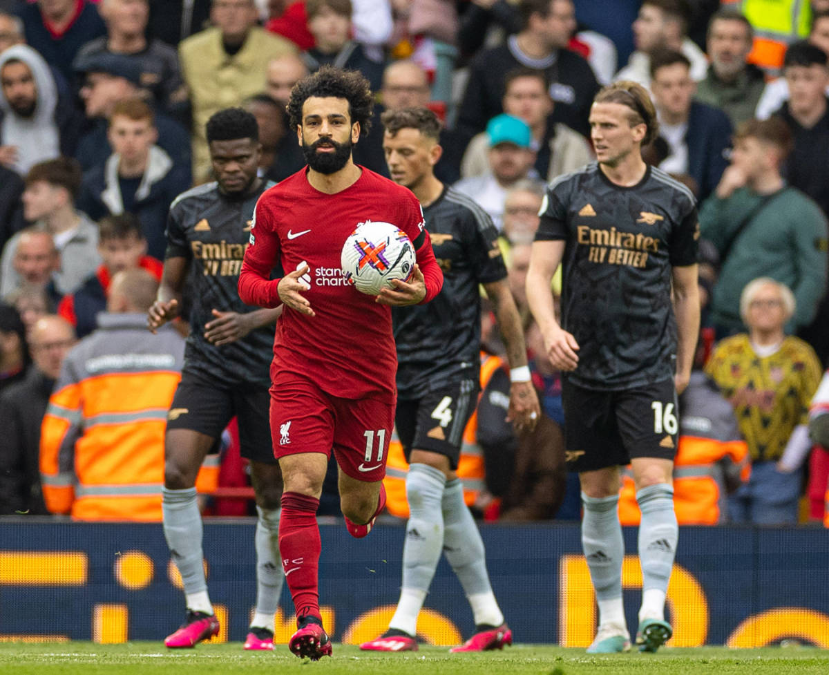 Mo Salah pictured running back to the halfway line with the ball after scoring for Liverpool against Arsenal in April 2023