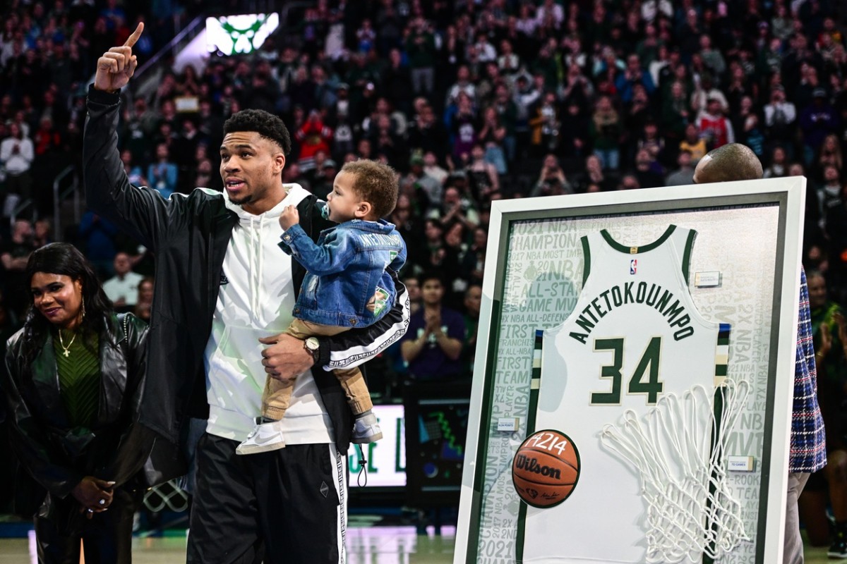 Milwaukee Bucks forward Giannis Antetokounmpo (34) holds his child, Shai, during ceremony recognizing his 10-year accomplishments with the team before game