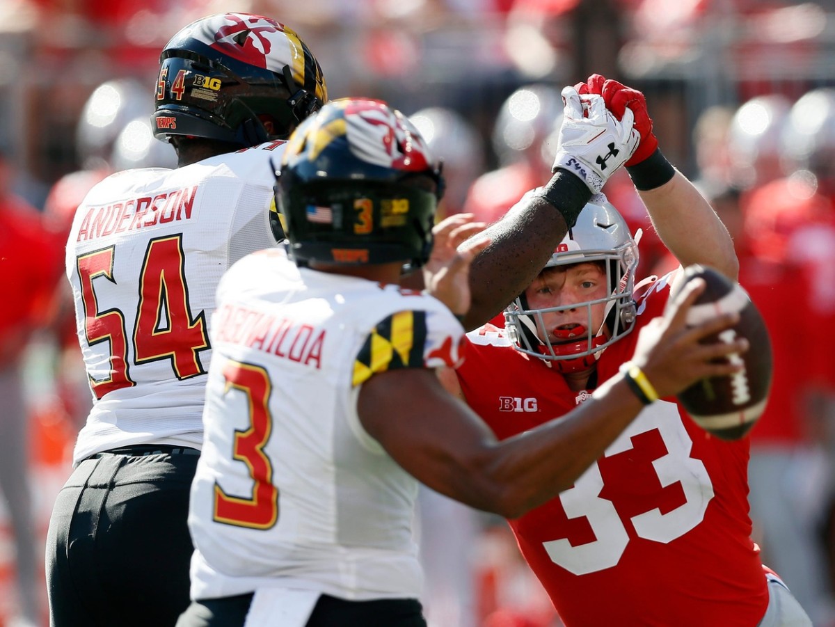 Ohio State Buckeyes defensive end Jack Sawyer (33) tries to past Maryland Terrapins offensive lineman Spencer Anderson (54) and go after Maryland Terrapins quarterback Taulia Tagovailoa (3) during the fourth quarter of their NCAA college football game at Ohio Stadium in Columbus, Ohio on October 9, 2021. Osu21mary Kwr 33