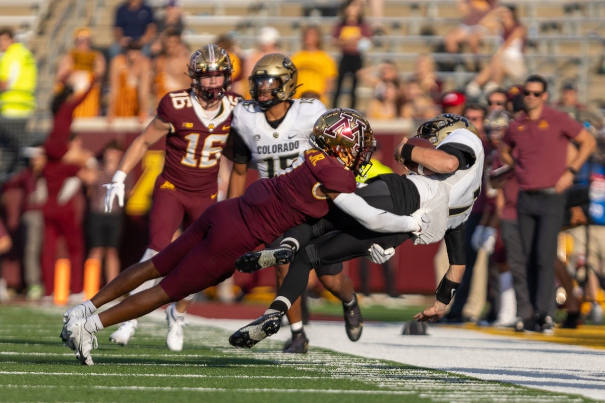 Sep 17, 2022; Minneapolis, Minnesota, USA; Colorado Buffaloes quarterback Owen McCown (7) is tackled by Minnesota Golden Gophers defensive back Beanie Bishop (7) in the fourth quarter at Huntington Bank Stadium.