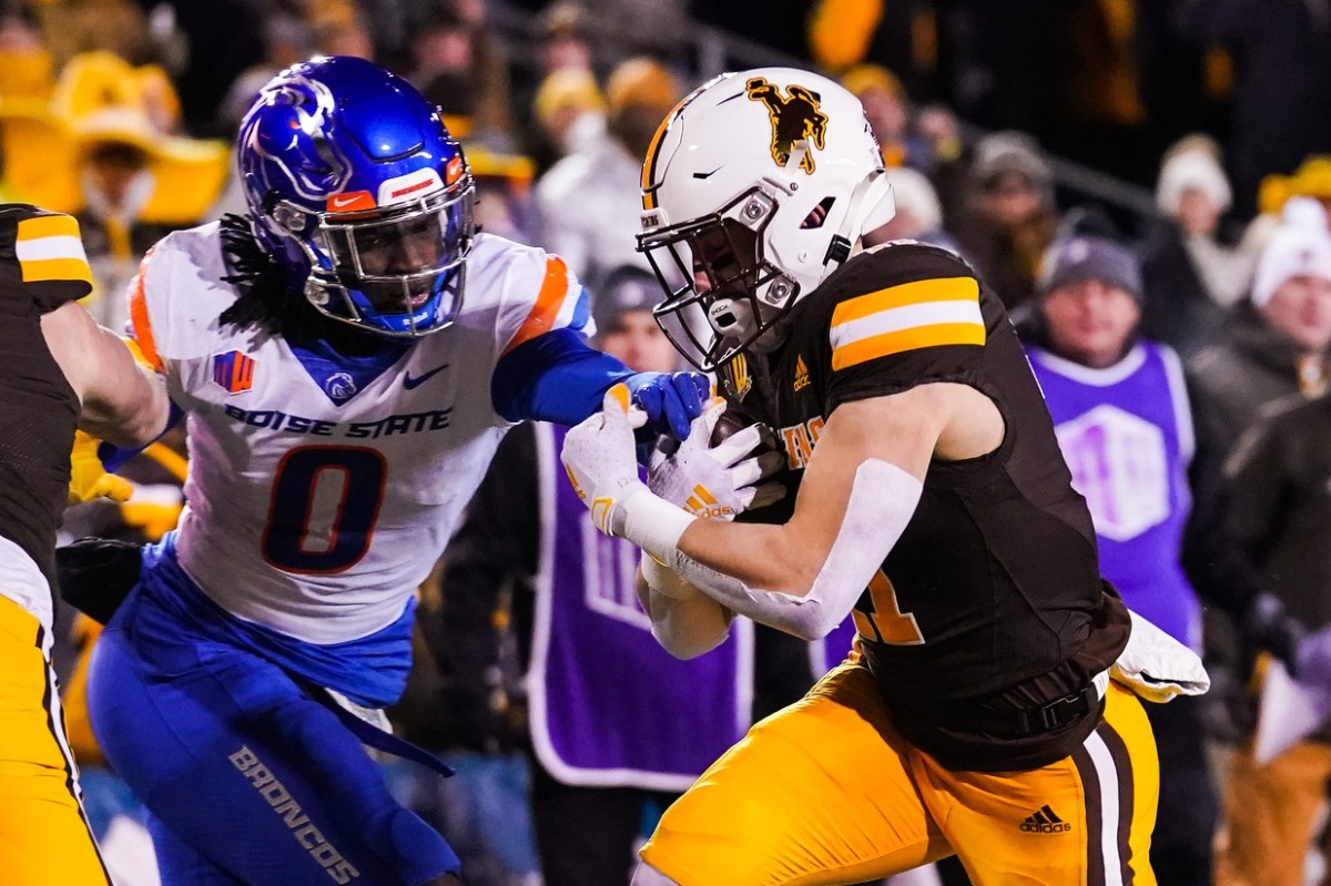 Nov 19, 2022; Laramie, Wyoming, USA; Wyoming Cowboys wide receiver Wyatt Wieland (11) scores a touchdown against Boise State Broncos safety JL Skinner (0) during the first quarter at Jonah Field at War Memorial Stadium. Mandatory Credit: Troy Babbitt-USA TODAY Sports