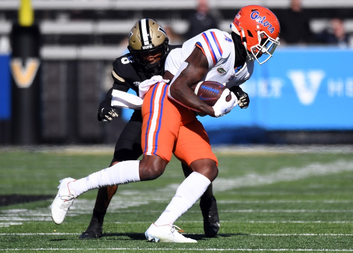 Nov 19, 2022; Nashville, Tennessee, USA; Florida Gators wide receiver Justin Shorter (4) is tackled by Vanderbilt Commodores cornerback Tyson Russell (8) after a reception during the first half at FirstBank Stadium. Mandatory Credit: Christopher Hanewinckel-USA TODAY Sports