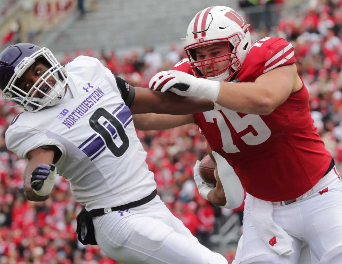 Wisconsin offensive lineman Joe Tippmann (75) knocks Northwestern defensive back Coco Azema (0) out of the way during the second quarter of their game Saturday, November 13, 2021 at Camp Randall Stadium in Madison, Wis. Wisconsin beat Northwestern 35-7. Uwgrid14 9