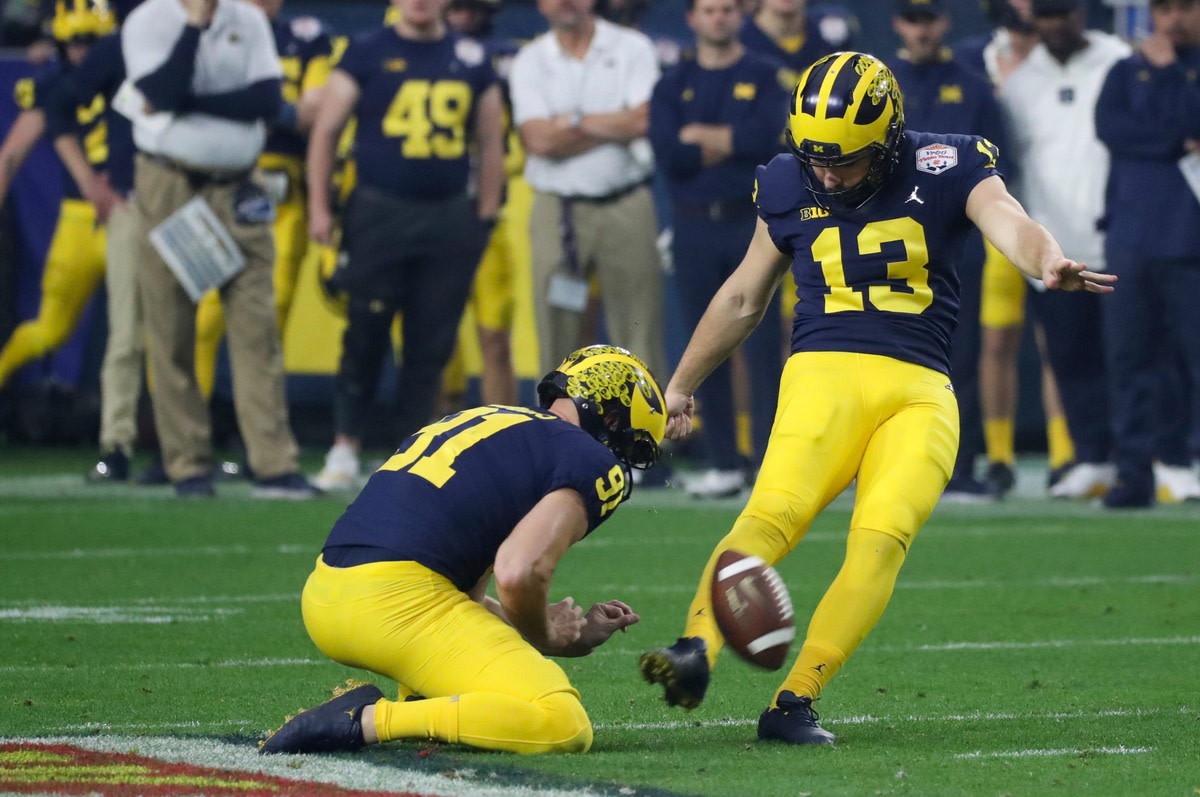 Michigan punter Brad Robbins holds the ball for Michigan kicker Jake Moody as he makes a 59-yard field goal in the second quarter of the Fiesta Bowl on Saturday, Dec. 31, 2022, in Glendale, Arizona.